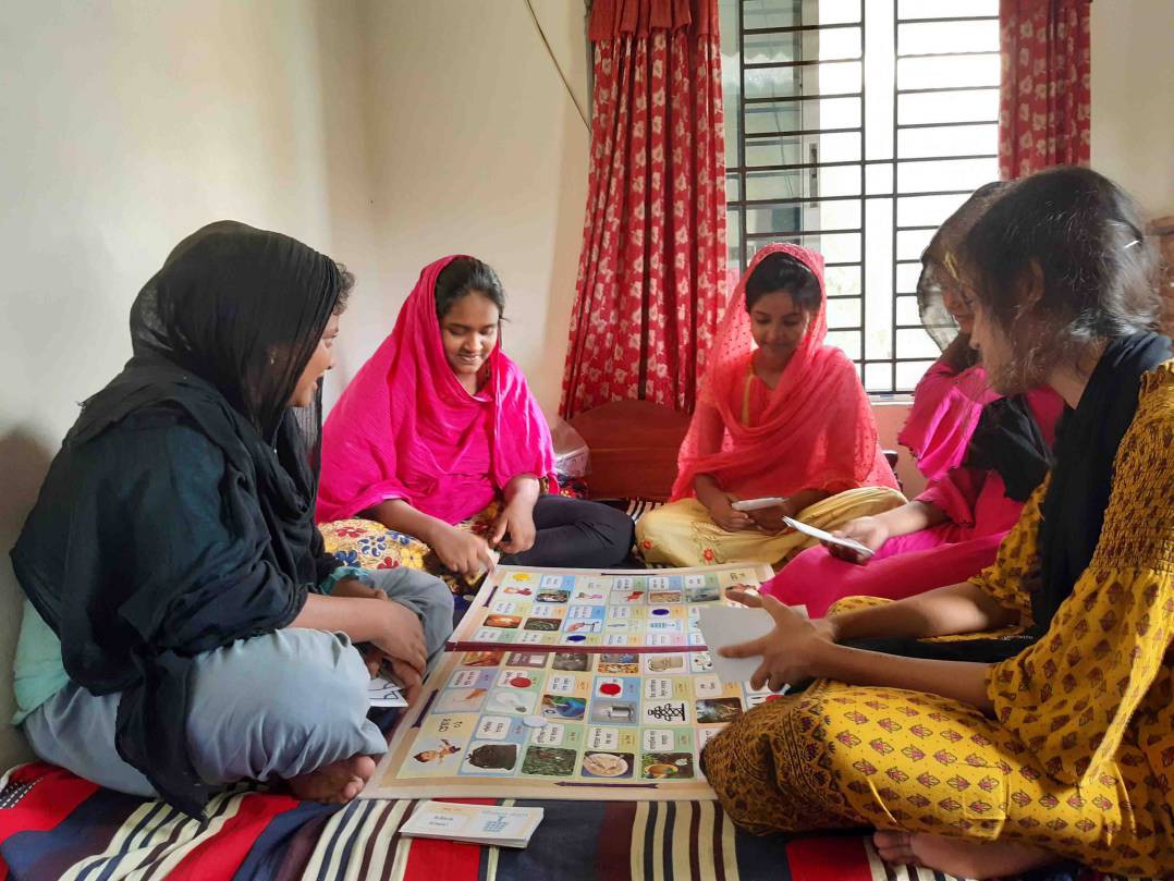 Opi and her friends practincing the sustainable consumption education game